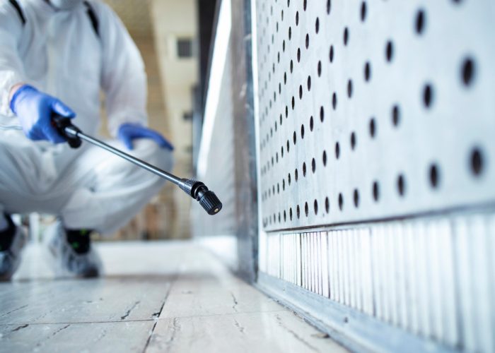 unrecognizable-person-white-chemical-protection-suit-doing-disinfection-public-areas-stop-spreading-highly-contagious-corona-virus